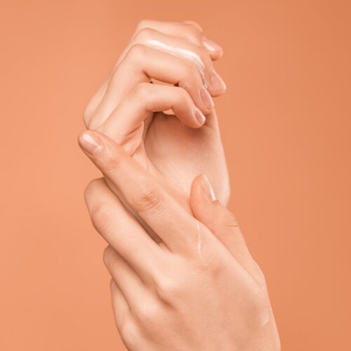 Persons Hand on Orange Background