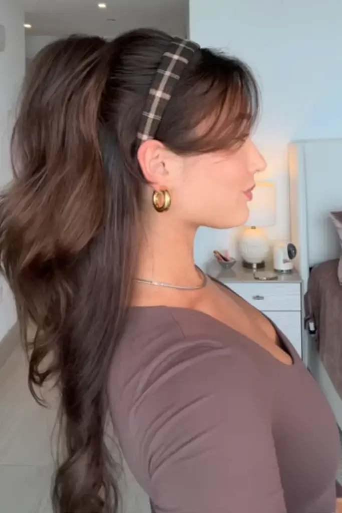 Half up hairstyle on woman with long brown hair with brown plaid headbang
