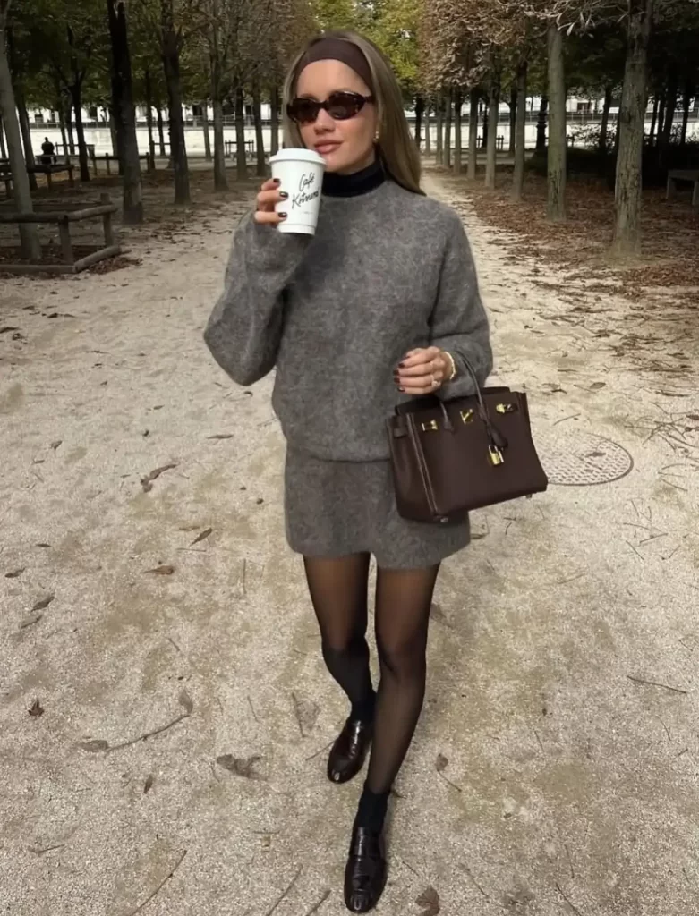casual and chic coordinated grey knit sweater and mini skirt outfit on young woman