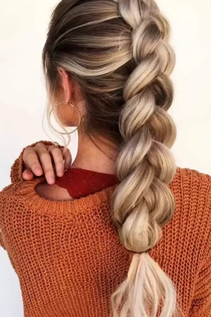 Pull-through/dragon braid done on blonde woman with long hair