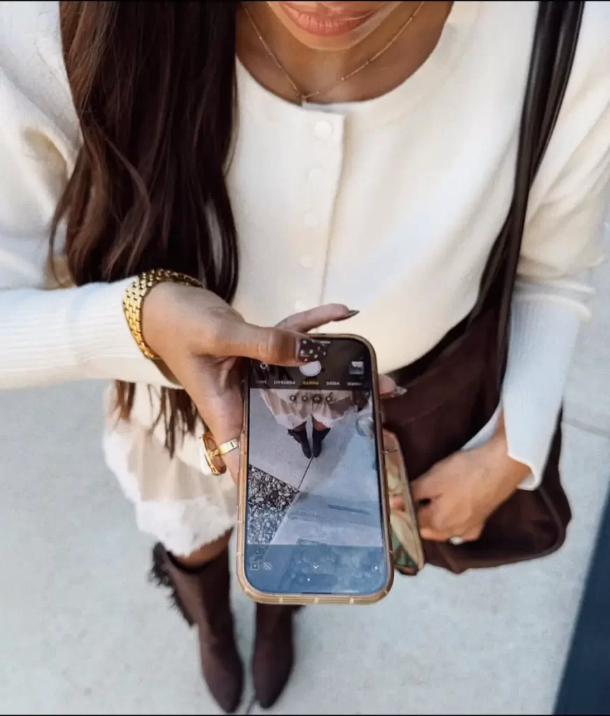woman taking selfie from above angle to get her brown boots