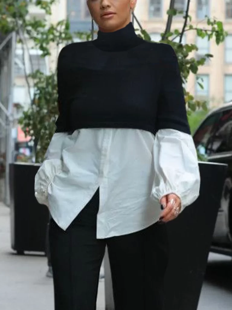 woman wearing white button down with puffy sleeves and cropped black sweater over