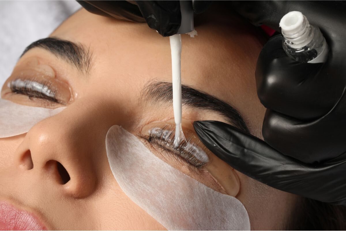 Lash tech performing lash lift on woman