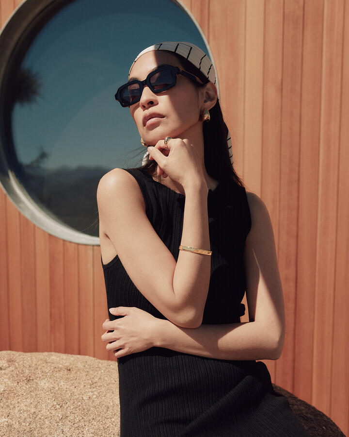 woman in black dress and sunglasses