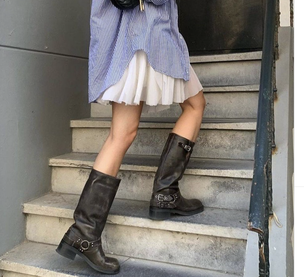 girl walking up stairs wearing moto boots