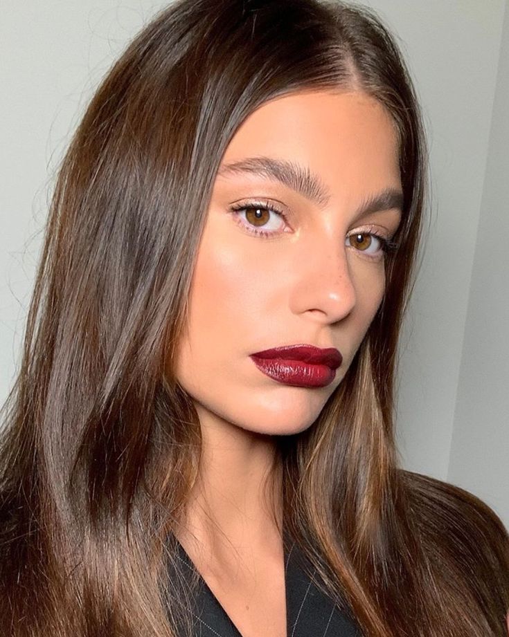 young woman with deep burgundy lipstick