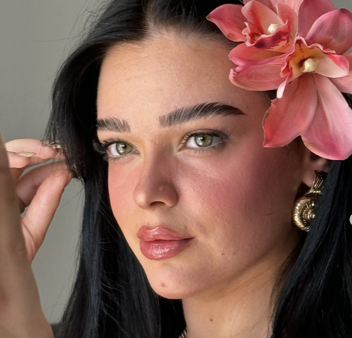 young woman with flower and pink blush