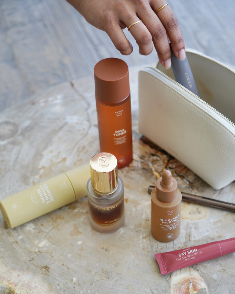 woman's hand with skincare bottles