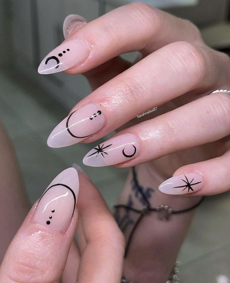 black minimalist nail art of crescent moon, stars, and dots on nude nails