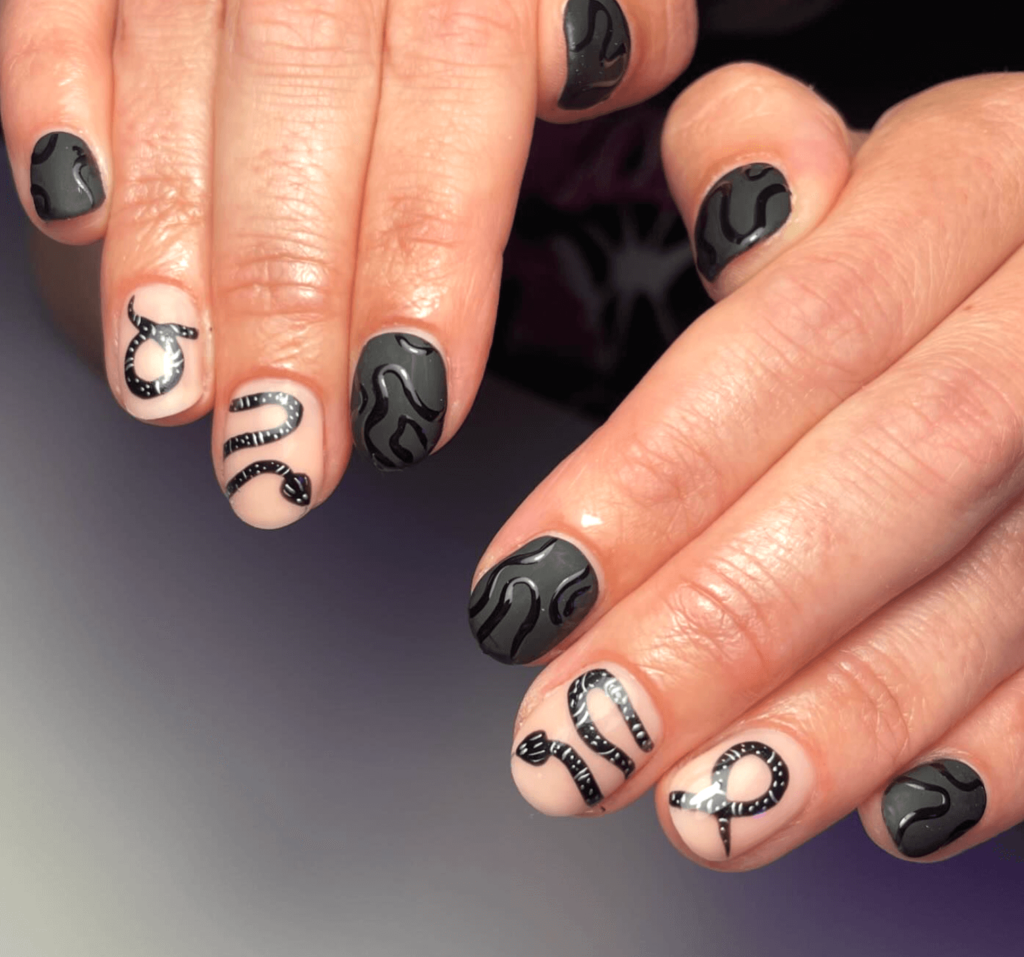 nail art design of a black snake across hands