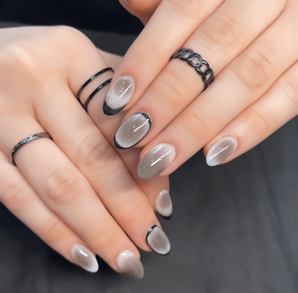 gradient grey nail art with grey glitter and black accents