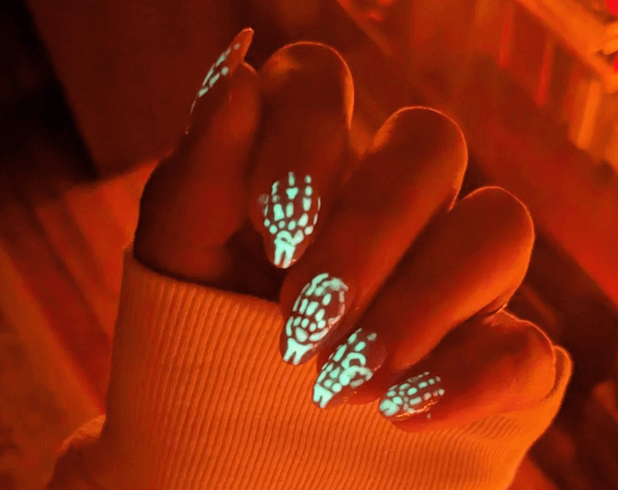 elegant Halloween nails featuring glow in the dark bone design