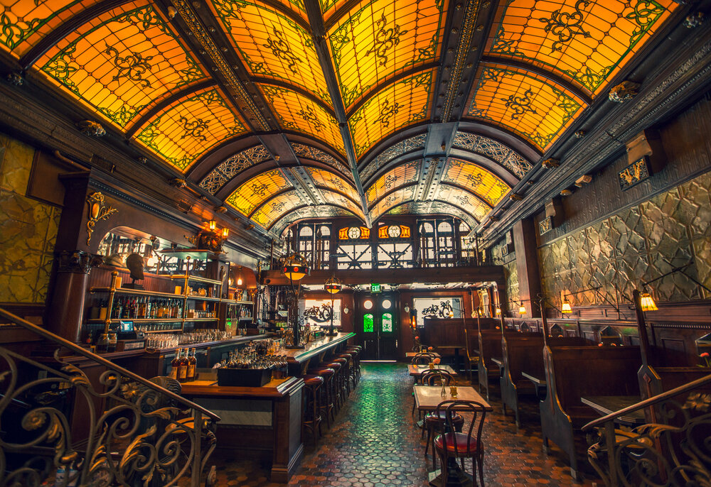 dark lit bar with stained glass roof 