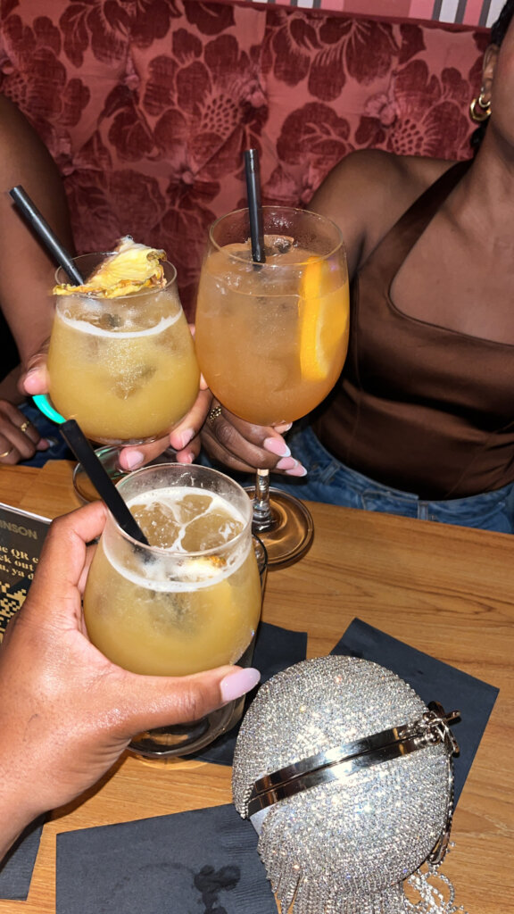 young women cheering with drinks