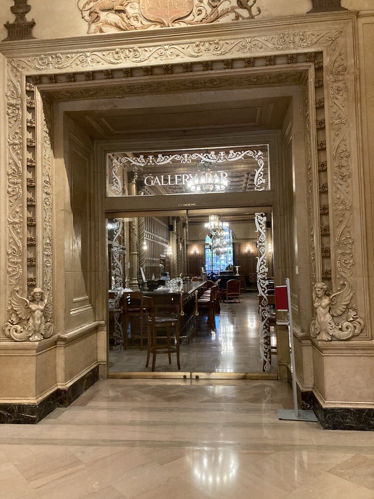 marble lobby with glass door leading to bar