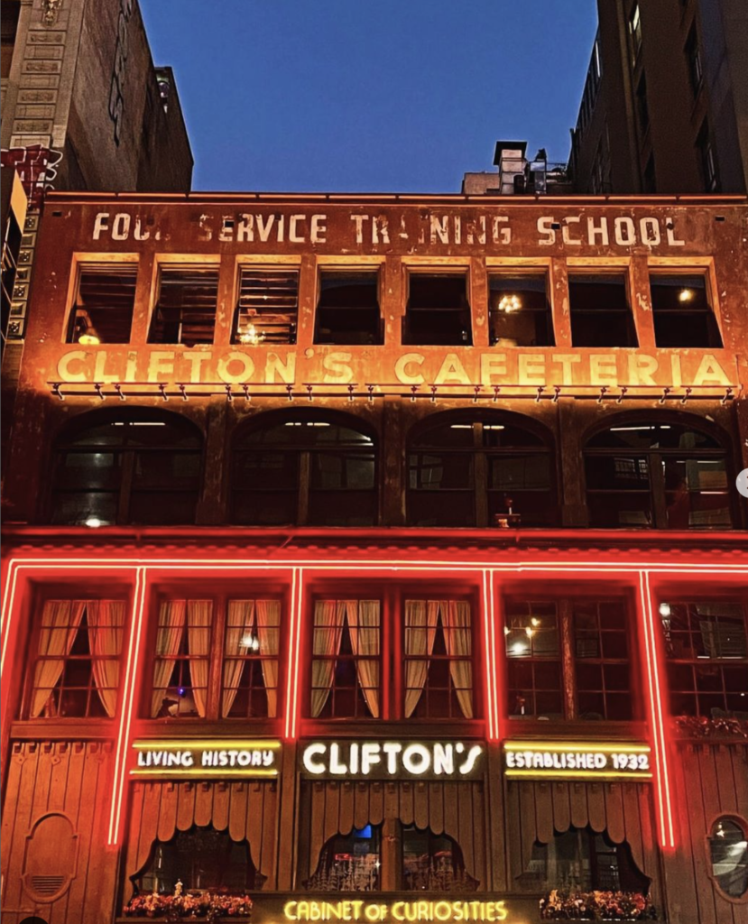 close up of the outside of Clifton's Republic with original signs at night