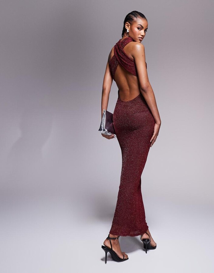 model wearing deep back glittery burgundy gown