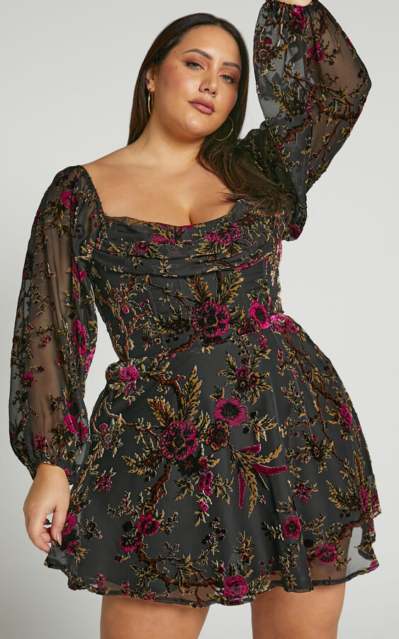 plus size model wearing black mini dress with dark floral velvet details