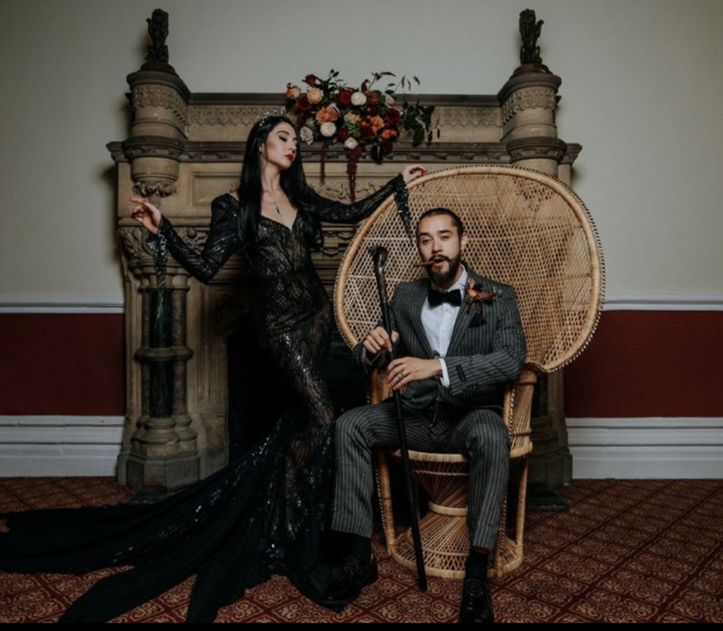 elegant couple dressed as Morticia and Gomez Addams