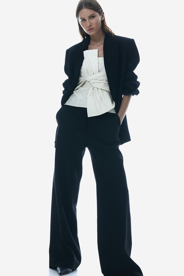 office holiday party outfit with black trousers and box detail white top