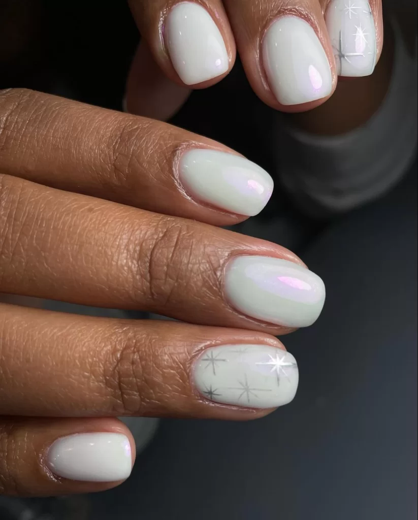 short white nails with subtle silver star accent on ring finger