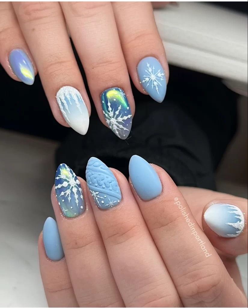 blue winter scenery nail art design with white icy accents