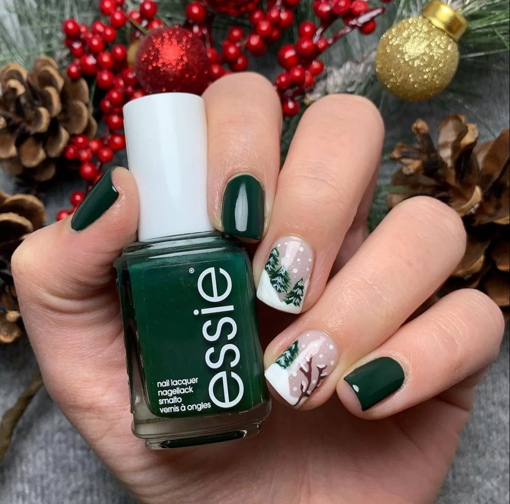 dark forest green nails with a snowy christmas tree nail design