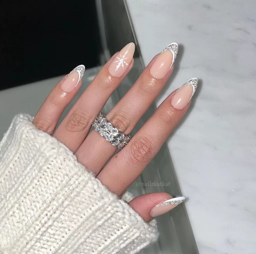 minimalist snowflake nail design with glitter french tips