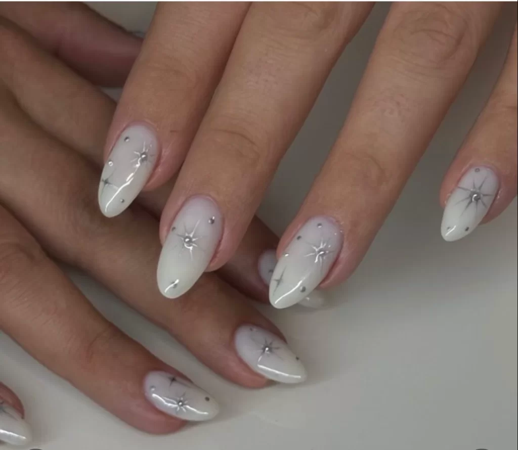 white base nails with silver star accents