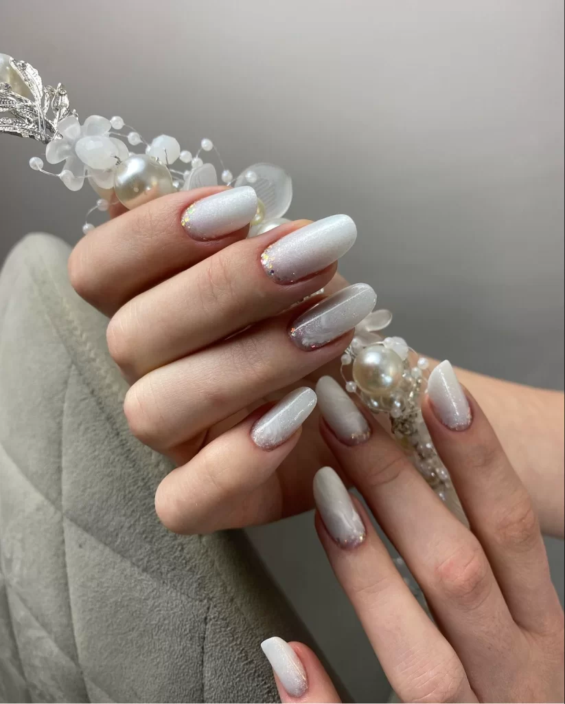 white bridal nails with gold glitter base