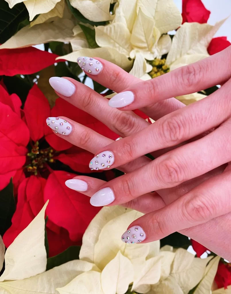 white nails with crystal accents glued on