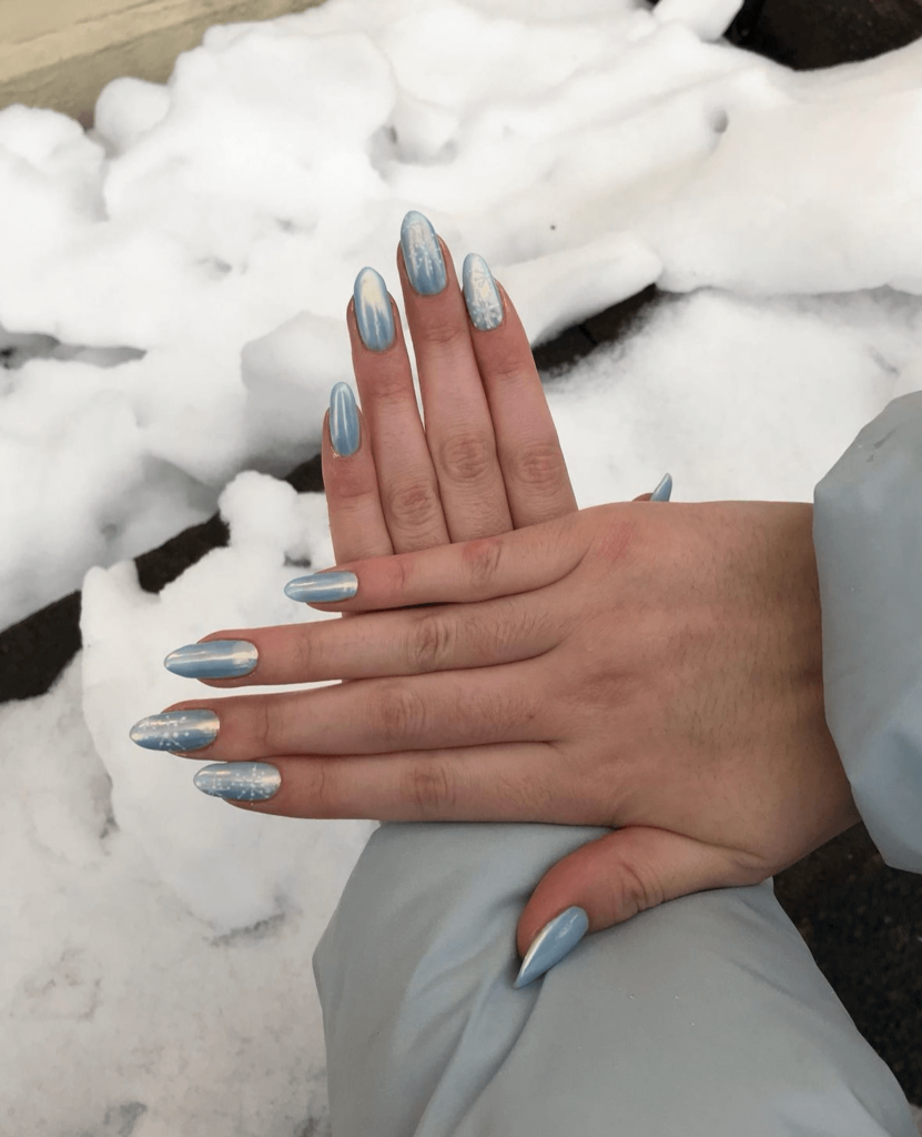 icy winter nail art with blue color and chrome finish