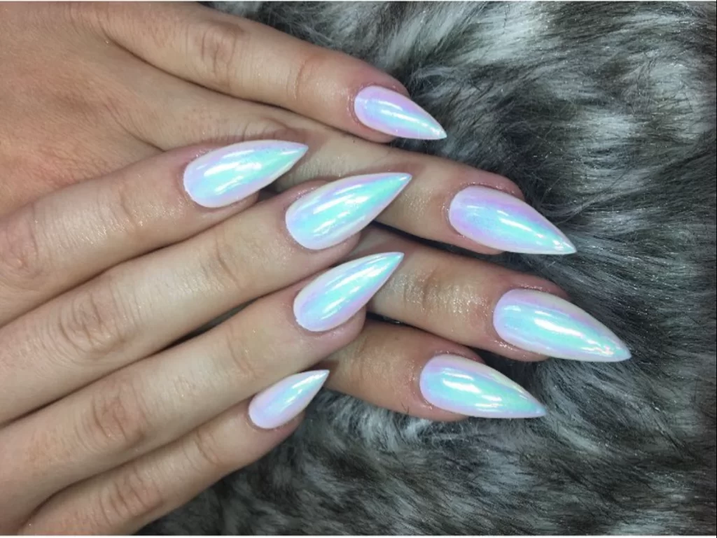 Iridescent white nail polish over stiletto shaped nails