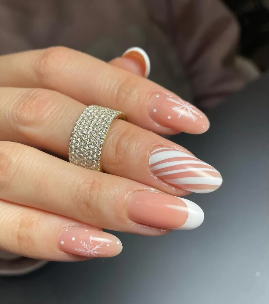 white holiday nail art with swirl and snowflake patterns