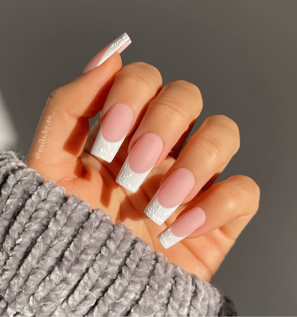 white french manicure with white snowflakes painted on tips