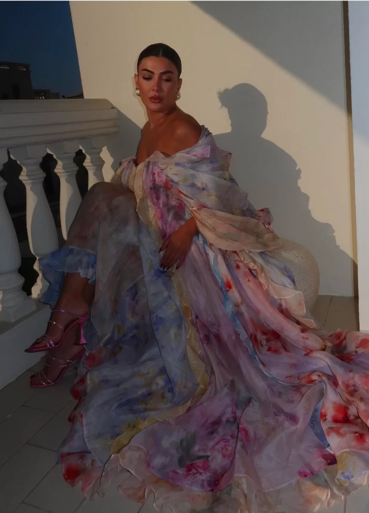 young woman during golden hour wearing romantic Zimmermann gown