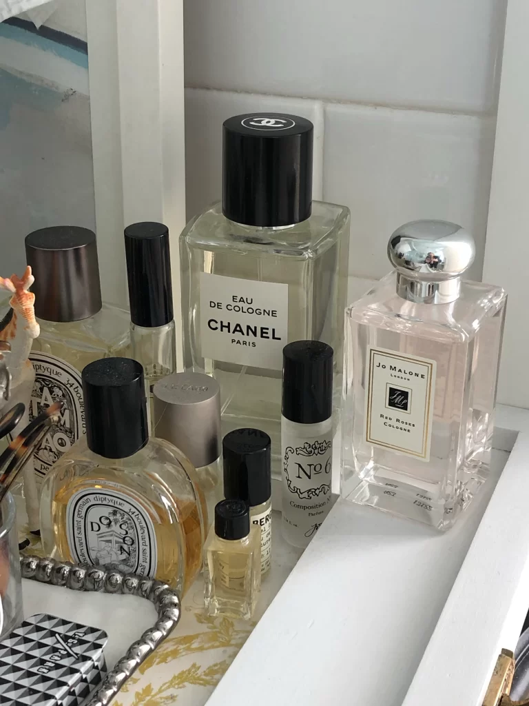 collection of perfumes displayed in white bathroom