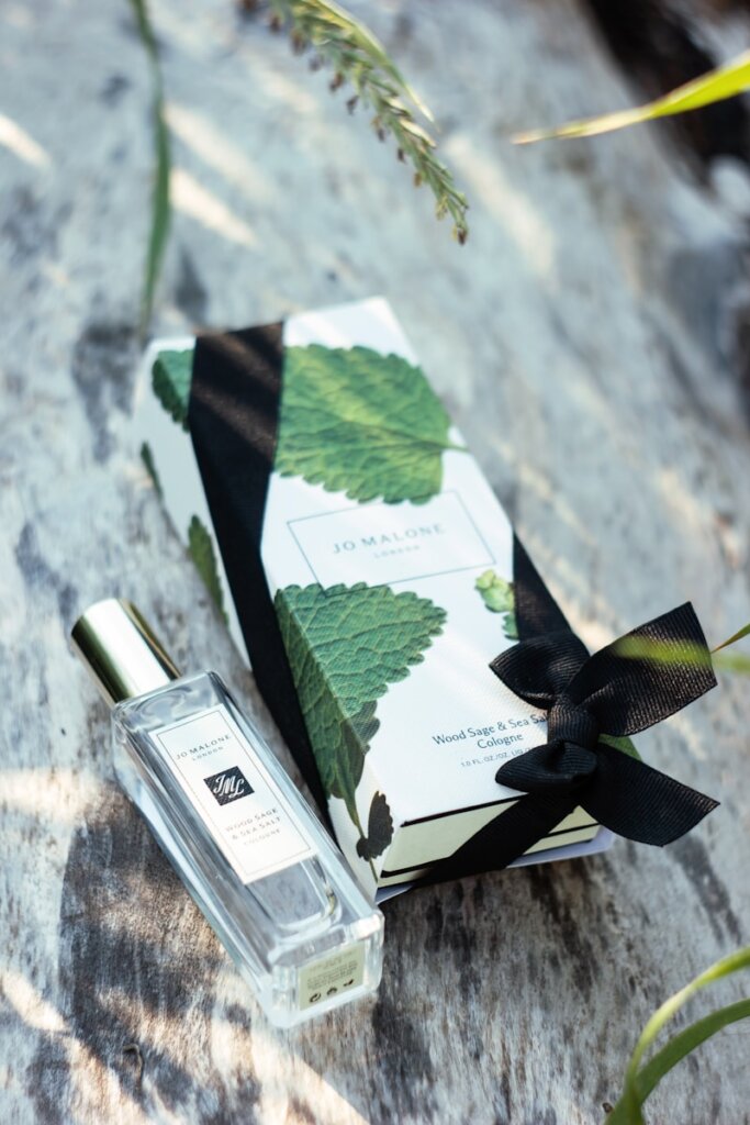 a bottle of cologne sitting on top of a wooden table