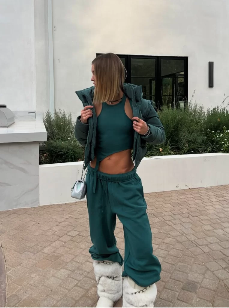 young influencer wearing green sweatpants outfit and matching puffer jacket