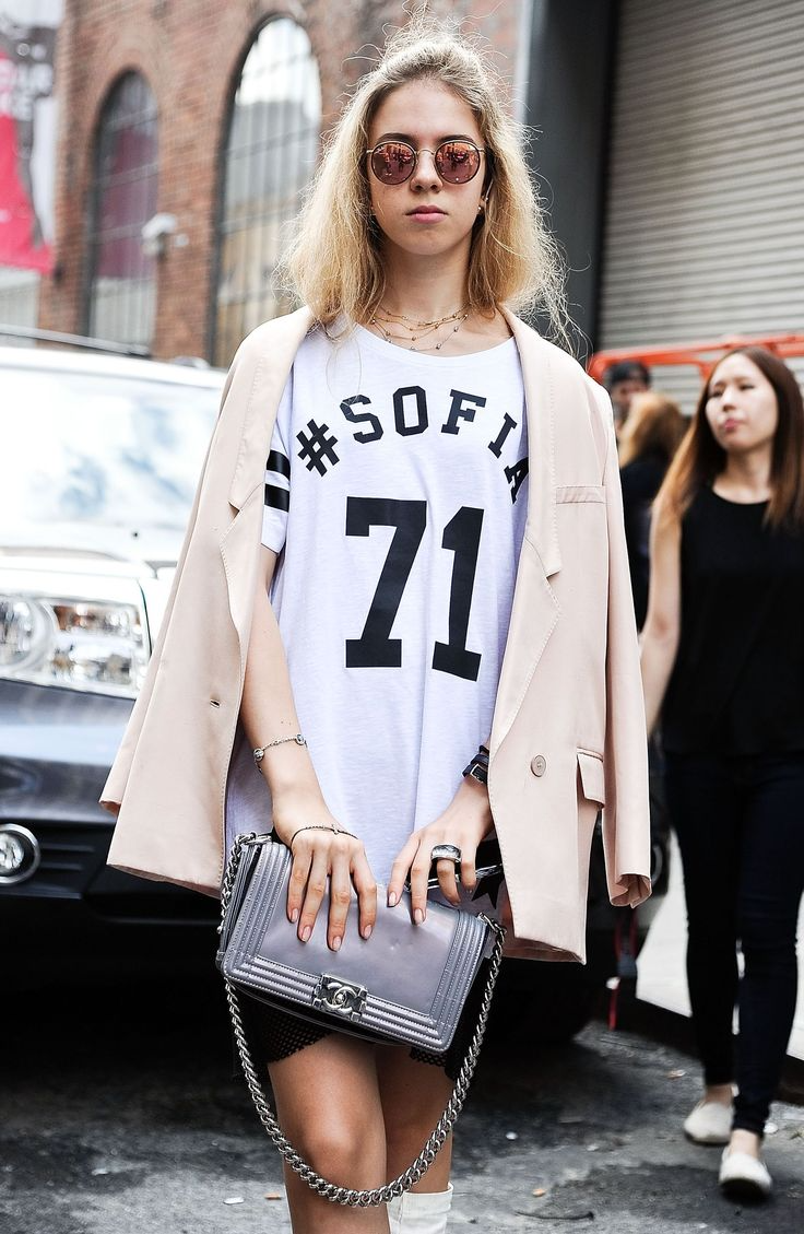 fashionable blond woman wearing sports jersey with blazer over