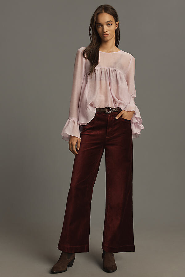 model wearing sheer pink top and dark red wide leg pants from Anthropologie Valentines day outfit winter ensemble