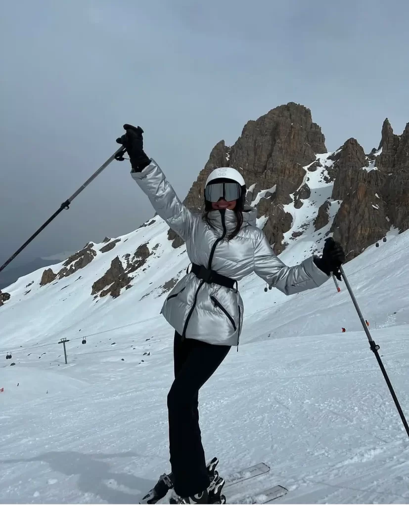 young woman skiing outfit metallic silver