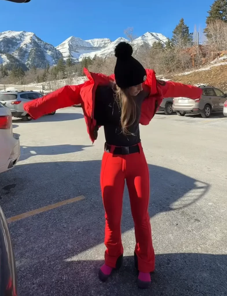 woman layering red ski outfit