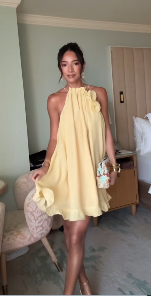 woman wearing soft yellow chiffon shift dress as a summer graduation outfit