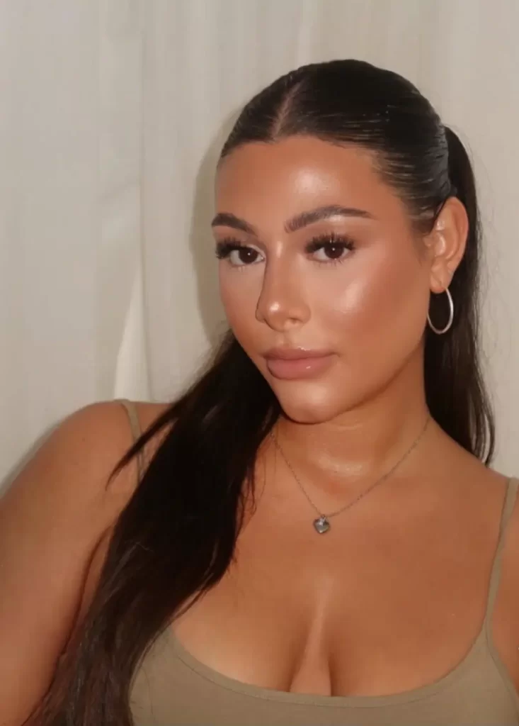 Close up of a shimmery and glowy bronze makeup look on young model with dark hair
