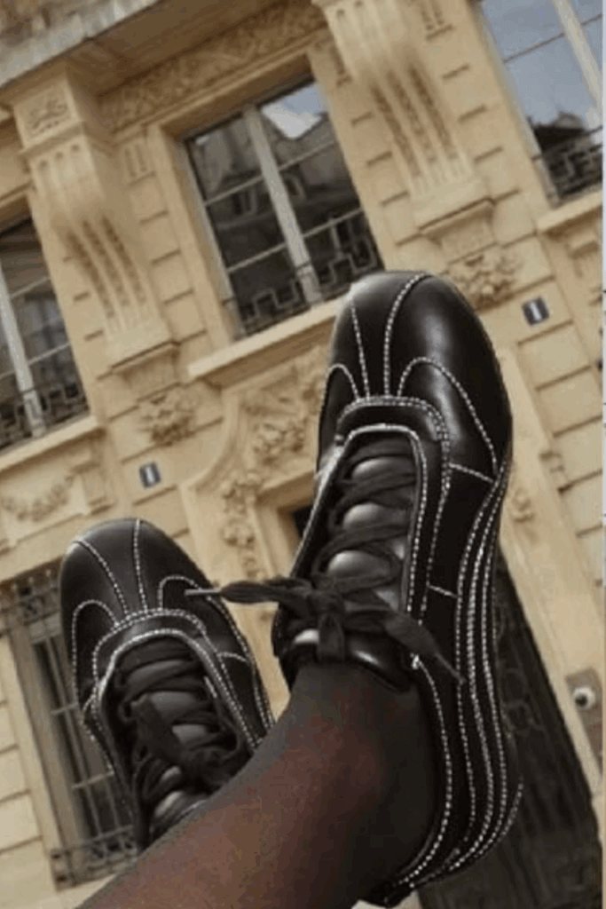 Close up of black sleek sneakers with white stitching perfect for a summer shoe for women