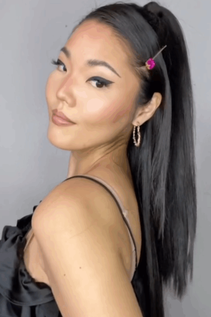 Asian woman with her hair in a sleek half up hairstyle and a pink hair clip