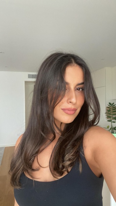 young woman with dark hair showing off her healthy hairstyle