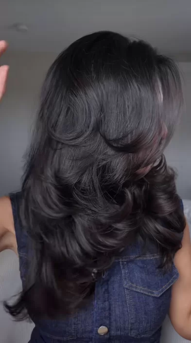 easy date night hair idea on a woman with dark brown medium length hair showing off soft waves