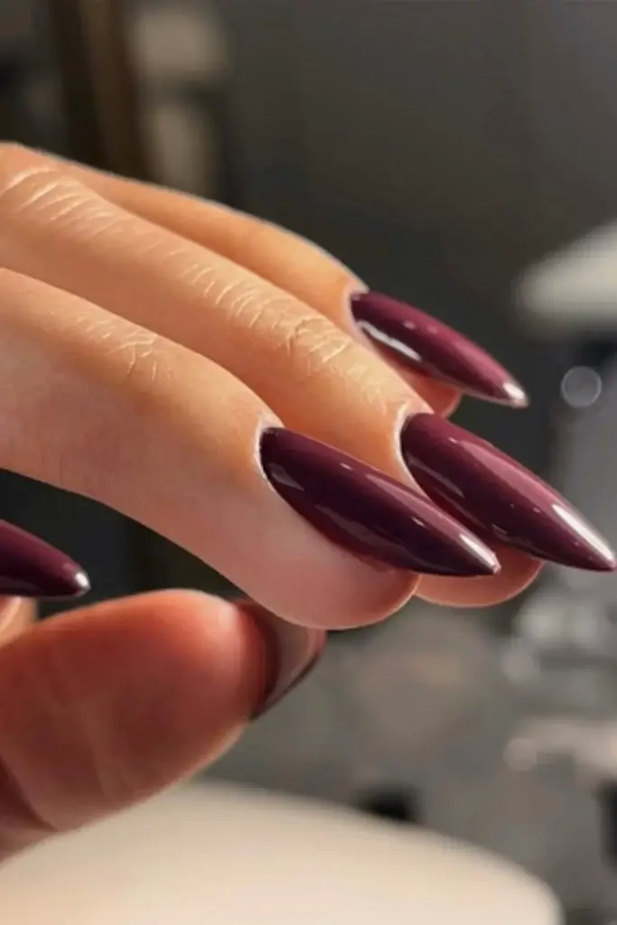 side profile of a woman's dark Bordeaux color Fall manicure